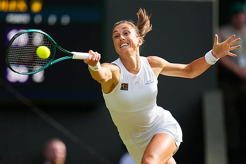 Petra Martic plays a forehand return to Iga Swiatek
